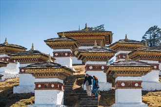 Visitors to the chortens or stupas at Dochula, the mountain pass  between Thimphu and Punakha, Western Bhutan