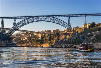Old Maria Pia Bridge over Douro River between Porto and Vila Nova de Gaia city in Portugal. nfante Henrique Bridge on background