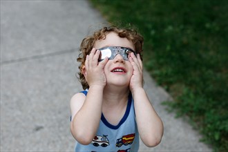 Boy watching solar eclipse