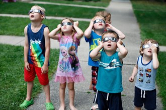 Group of children watching solar eclipse