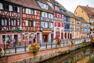 COLMAR, FRANCE - September 10, 2017: Cityscaspe view on the old town with beautiful half-timbered houses and water canal in Colmar, famous french town in Alsace region