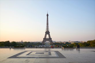 PARIS, FRANCE - JULY 7, 2018: Eiffel tower, some people in a clear summer morning in Paris, France