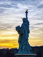 Replica of the Liberty Statue against the sunset in Paris