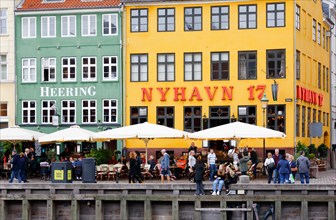 Copenhagen, Denmark - September 4, 2019: Buildings, restaurants and people at the Nyhavn street.