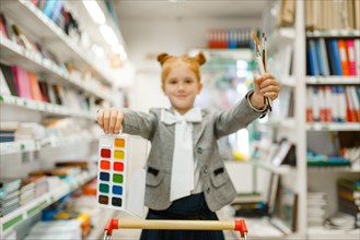 School girl with paints and brushes, stationery
