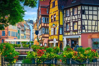 Popular touristic place and travel location. Picturesque street view with colorful buildings and flowers, Colmar, France, Europe