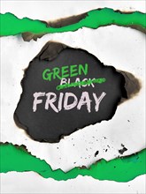 Green Friday concept, hole burned in white and green paper. Text "Black Friday Sale"  with word "Black" crossed out. Strikethrough or strikeout effect
