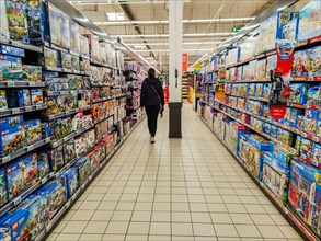Puilboreau, France - October 14, 2020:Woman walking back view in the toy department of a supermarket
