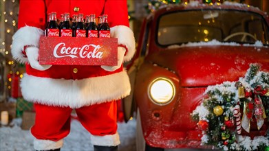 06.11.2020 Russia, Novosibirsk: Portrait of Santa Claus holding a package of Coca Cola bottles. Christmas greeting card