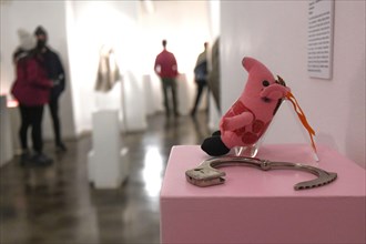 Museum of Broken Relationships: Handcuffs and stuffed pig toy. Zagreb, Croatia