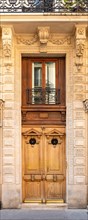 Paris, an ancient door, typical building in the 11e arrondissement
