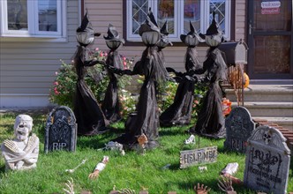 A house in Bayside, decorated for Halloween with dancing witches, skeletons, sculls & tombstones. In Queens, New York City,