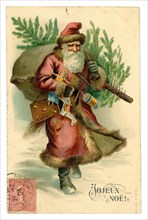Edwardian era greetings card postcard of Father Christmas carrying presents and a tree with French stamp on front, posted / dated 24 December 1904