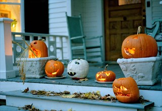Halloween pumpkins glowing on a porch in Sharon, Connecticut, New England, USA.