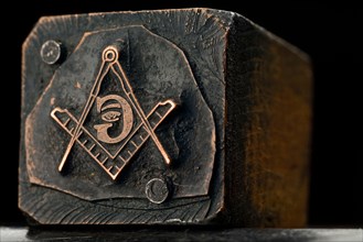 a freemason seal against dark background