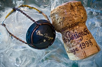 Dom Perignon wire retaining frame cap and vintage champagne cork in ice cooler