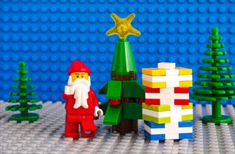Tambov, Russian Federation - November 06, 2017 Lego Santa Claus and stack of presents near christmas tree. Studio shot.