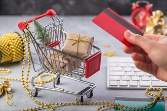 Small red shopping cart with keyboard for Internet online shopping concept christmas gifts. save time.