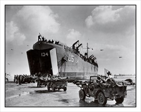 D-Day+6 World War II Operation Overlord American casualties US Navy LST-134 and LST-325 beached at Normandy France, as jeeps driving along the invasion beach carry casualties to the waiting vessels, 1...