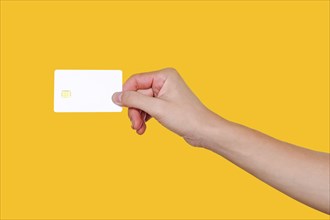 Blank Credit Card, Empty white credit card with chip in hand holding on yellow background with clipping path for mockup
