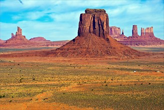 Monument Valley, houses dwarfed by red rock formations