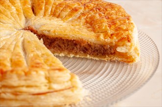 Pastry dough Galette des Rois with cream frangipane with white overground almond
