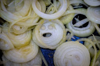 Chopped onions in a pan with one slice looking like a face