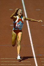 Florence Griffith Joyner (USA)  wins the gold medal in the Women's 100m Final at the 1988 Olympic Summer Games.