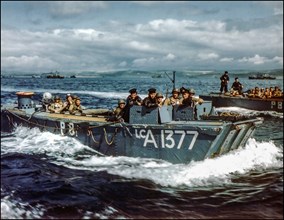 D-Day rehearsals WW2 1944  British Navy Landing Craft LCA-1377 in preparations for D-Day, carries American troops to a ship, in a British port during preparations for the Normandy invasion, circa May-...