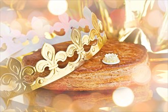 Galette des rois, french kingcake with a  crown, holiday bokeh lights