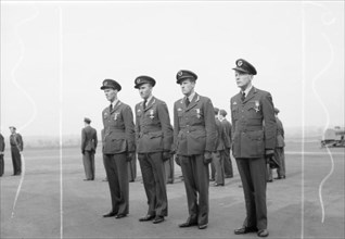 Royal Air Force- 2nd Tactical Air Force, 1943-1945. Four Norwegian fighter pilots standing to attention following the presentation of awards to each by Air Chief Marshal Sir Trafford Leigh-Mallory, Co...