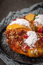 Bolo Rei or Kings Cake is a traditional Xmas cake with fruits raisins nut and icing on kitcthen countertop. Is made for Christmas, Carnavale or Mardi