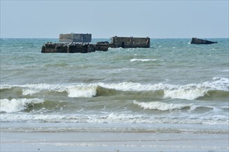 Second World War Two concrete boxes, known as Phoenix caissons in front of WW2 Gold Beach at Asnelles, Normandy, France