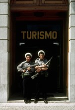 Portuguese marines stand guard outside the tourism office in Lisbon, with flowers in their guns, following the 'Carnation Revolution, the bloodless military coup of 25 April 1974 which deposed the aut...