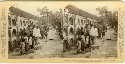 Praying for the souls of departed friends - Santa Cruz Cemetery, Manila, Philippines, Stereograph shows Filippino men and women