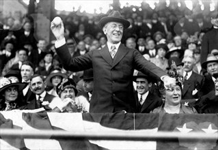 President Woodrow Wilson throwing out the first ball, opening day, 1916; among those present are Edith Bolling Galt Wilson and Mrs. Ida Wilson. Thomas Woodrow Wilson (December 28, 1856 - February 3, 1...