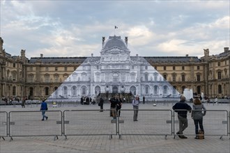 Louvre museum pyramid covered with thousands of paper sheets to make it disappear with an optical illusion.