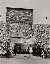 Torch-bearer arrives at opening ceremony, Olympic Games, London, 1948.
