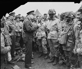 General Dwight D. Eisenhower gives the order of the Day.  "Full victory-nothing else" to paratroopers in England, just before they board their airplanes to participate in the first assault in the inva...