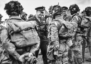General Dwight D. Eisenhower gives the order of the day, "Full victory, nothing less" to paratroopers somewhere in England just before they board their planes to take part in the first assault of the ...