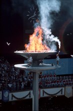 Seoul Korea, 1988: Korean athletes light the Olympic cauldron during opening ceremonies for the 1988 Summer Games. ©Bob Daemmrich