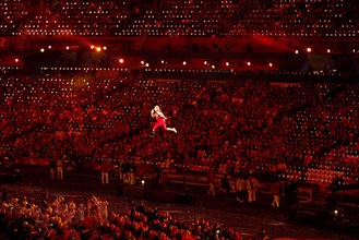 London England, August 29 2012: A disabled athlete, suspended by invisible wires, appears to run through the air above the stadium floor during the Opening Ceremonies of the 2012 London Paralympic Gam...