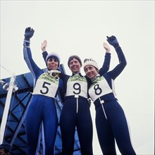 Female skiers stand on a podium after a race, Isere, France, 1968
