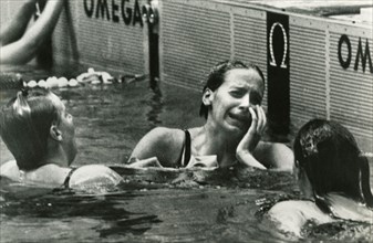 American swimmer athlete Kaye Hall (center) weeps after having won the 100-meter backstroke at the Olympic Games, Mexico City 1968