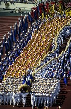 Seoul South Korea, 1988: Hundreds of costumed performers enter the Jamsil Olympic Stadium during opening ceremonies of the 1988 Seoul Olympic Games. ©Bob Daemmrich