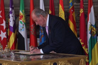 The King Juan Carlos I de Borbon of Spain signs the law on his abdication at the Royal Palace of Madrid in Madrid, June 18, 2014. The King signed on Wednesday the law on his abdication in order to giv...