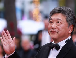 230518 -- CANNES, May 18, 2023 -- Japanese director Kore-Eda Hirokazu poses as he arrives for the screening of the film Kaibutsu Monster which will compete for the Palme d Or during the 76th edition o...