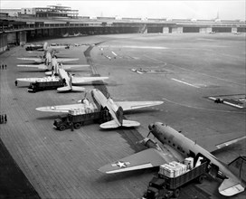 Berlin Airlift. U.S. Navy Douglas R4D and U.S. Air Force C-47 aircraft unload at Tempelhof Airport during the Berlin Airlift. The Berlin Blockade lasted from the 24 June 1948 to 12 May 1949.