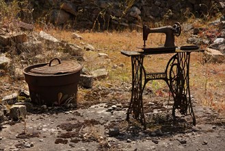 The remains of a Singer sowing machine and a cooking pot in the martyred village of Oradour sur Glane Limousin France