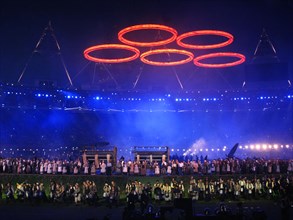 Some of the cast for the final rehearsal for the opening ceremony of the 30th Olympic Games under Olympic Rings